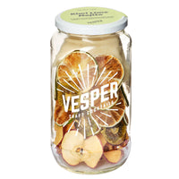 Jar of Vesper craft cocktail mix with fruit pieces on a white background